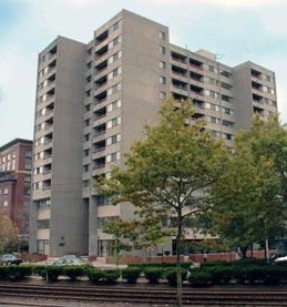 Beacon Park Apartments tower behind trees on Park Street