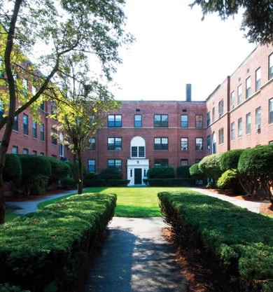 Brick apartment buildings around the landscaped Clinton and Prospect courtyard