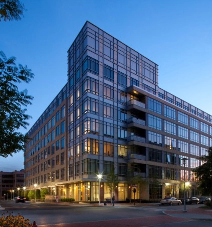 Exterior of 75 Station Landing at dusk, with glass windows and street-level entrances