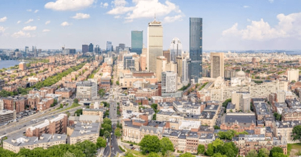 Elevated view of city blocks, high-rise buildings and tree-lined streets.