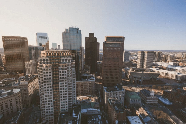 Elevated view of high-rise buildings and lower city blocks in daylight.