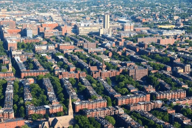 Brick rowhouses and tree-lined streets seen from above
