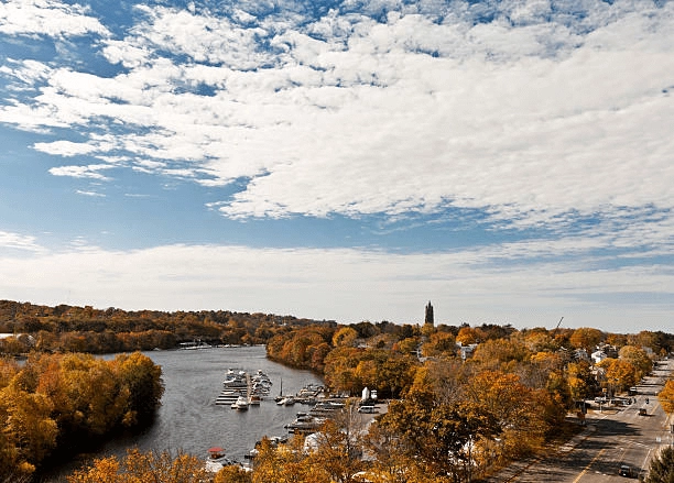 River, moored boats and autumn trees beside a road