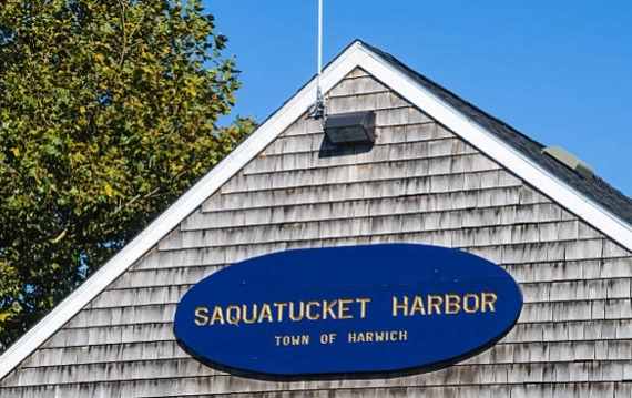 Saquatucket Harbor, Town of Harwich sign on a shingle-clad building