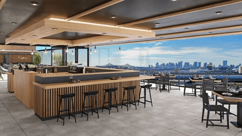 Rendering of a proposed rooftop restaurant with bar seating and skyline views.