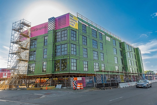 Building under construction with scaffolding and Graphic Lofts banners.
