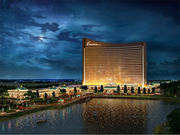 Illustration of the Encore tower and waterfront grounds at night.
