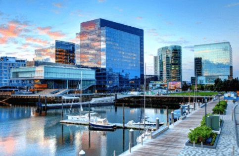 Marina and glass buildings at dusk.