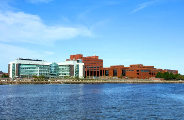 Brick-and-glass buildings across open water.
