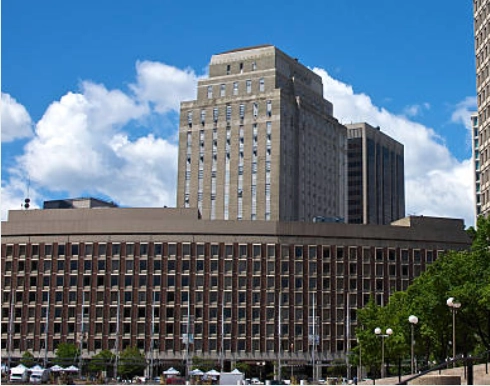 Long office block with a taller building behind.
