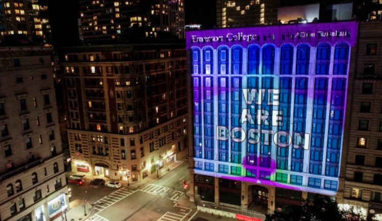 Building facade illuminated with We Are Boston lettering.
