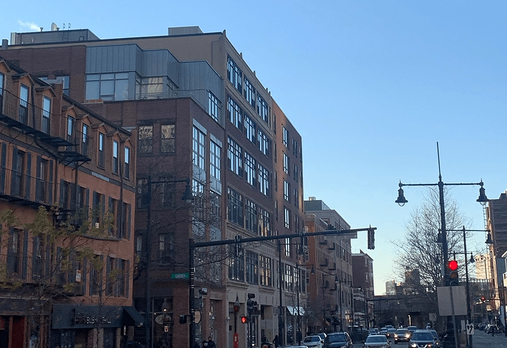Brick buildings and traffic along a city street.