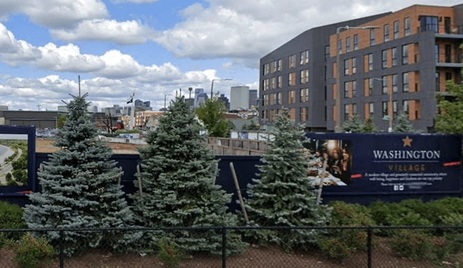 Washington Village sign and fenced construction site in the original report