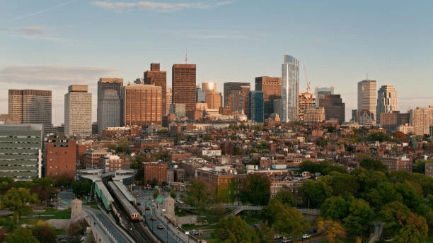 City skyline and rows of brick buildings beside a road