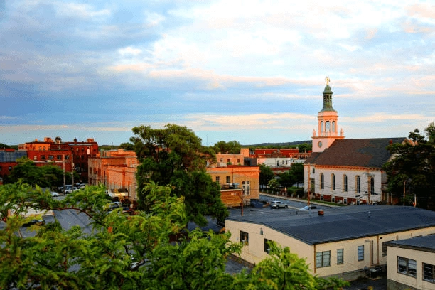 Town buildings, trees and a church steeple