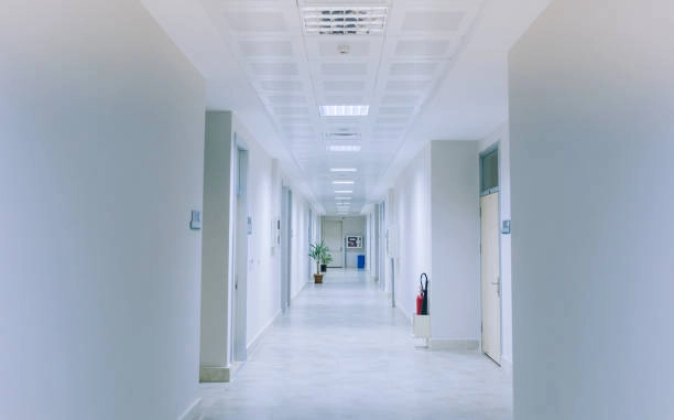 Light-colored corridor with doorways and overhead lighting
