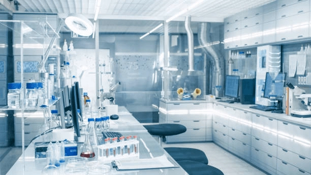 Laboratory benches and equipment beneath exposed ceiling services