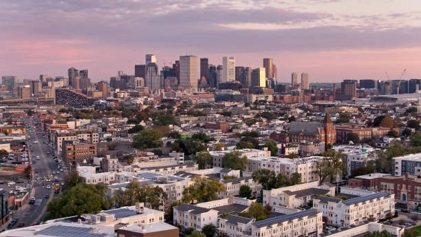 City buildings beneath a pink evening sky