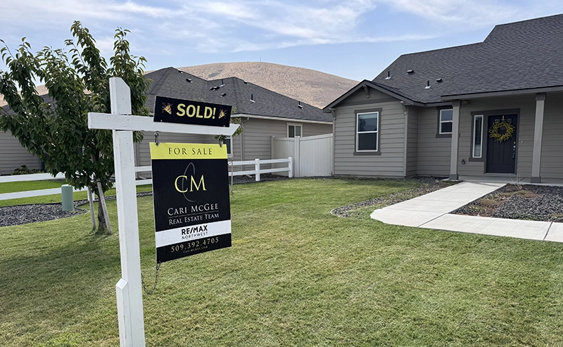 Photo of a Tri-Cities home with a Cari McGee Team "Sold" sign in the front yard