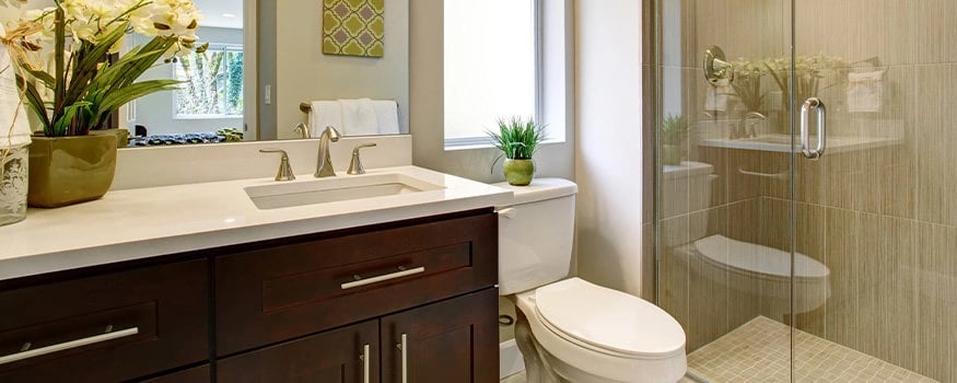 bathroom with vanity, granite countertops, and tiled shower