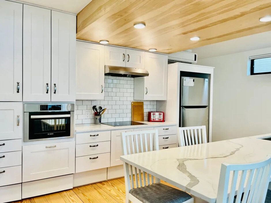 Unit One — Ground-Floor Comfort Eat-in kitchen with quartz counters, Bosch and Miele appliances, and natural light.