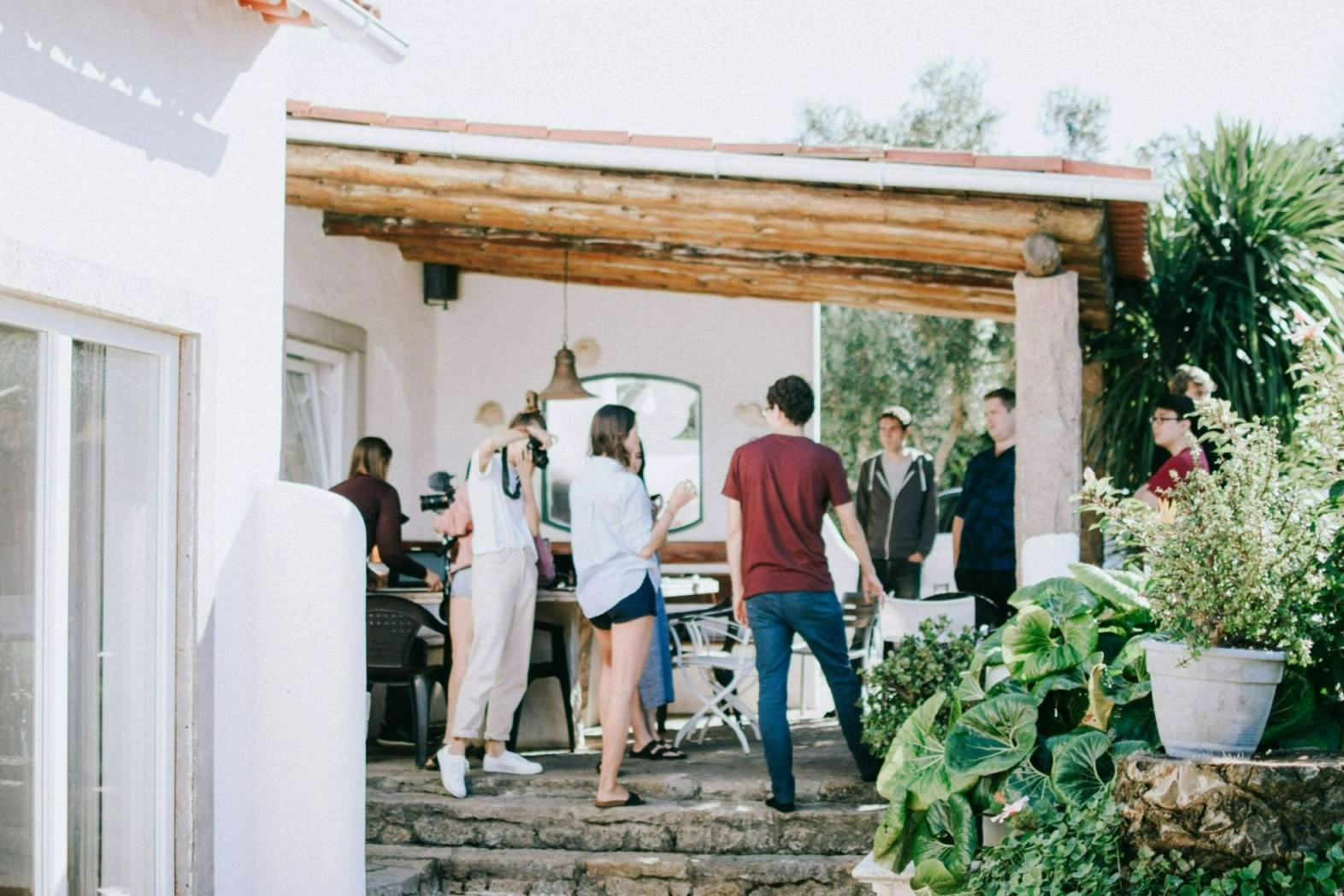 People standing around on a back porch.