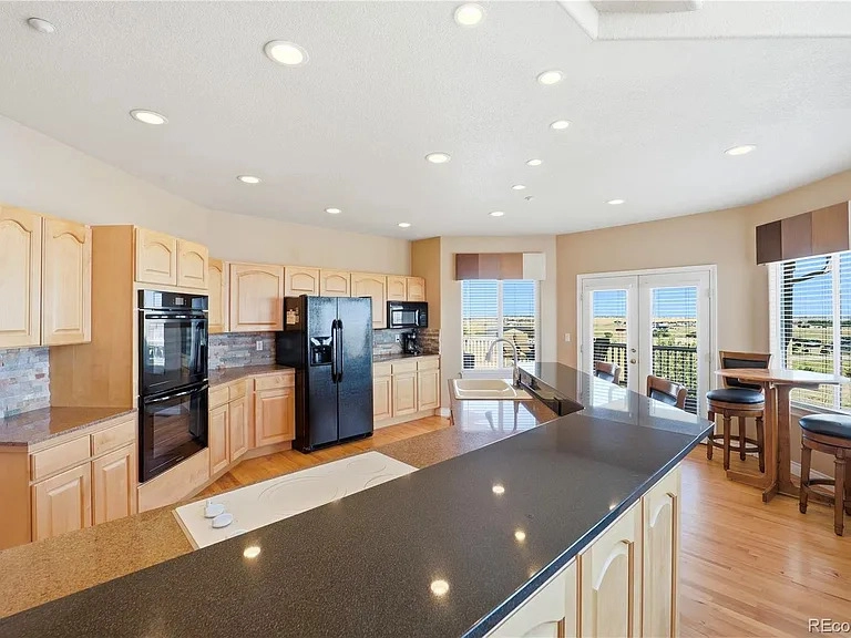 Great room and window-wall views at 35880 E 149th Court, Hudson, CO