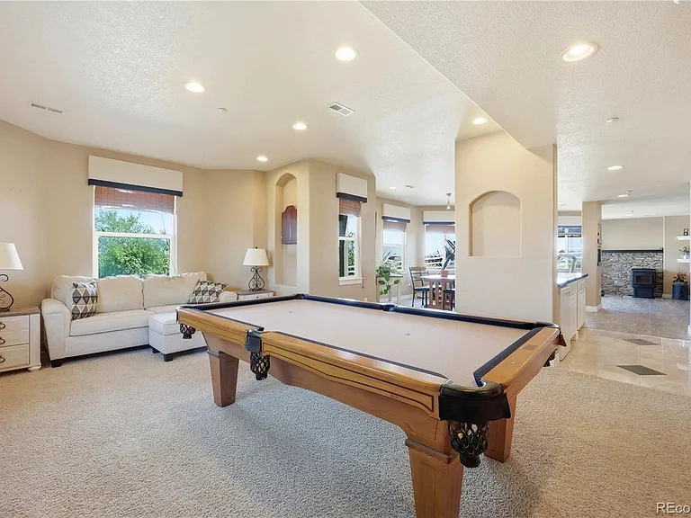 Walkout basement rec room with pool table at 35880 E 149th Court, Hudson, CO