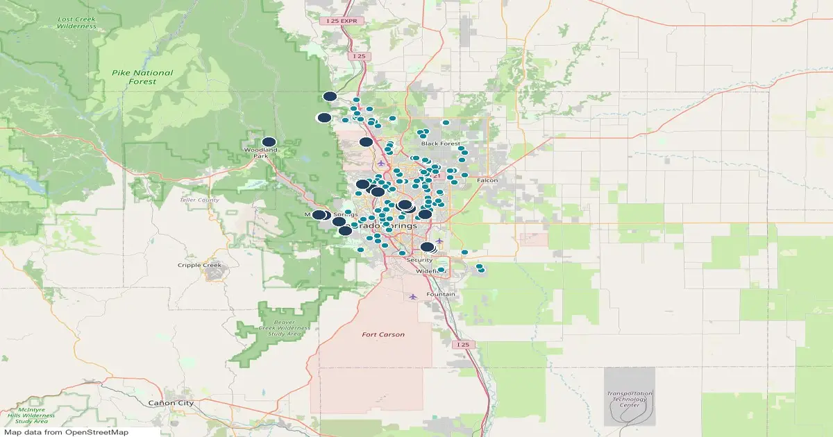 Map of the Colorado Springs area, Colorado, showing 22 trailheads as pins and 139 homes for sale whose listings name a trail as teal dots