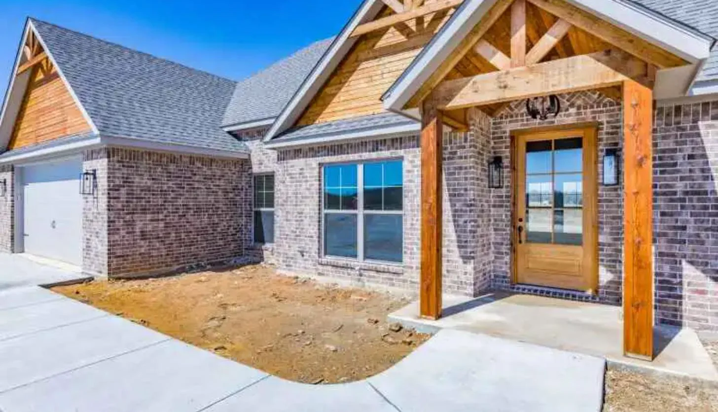 Brick craftsman home with cedar gables and covered front entry built by Ward Construction in Oklahoma