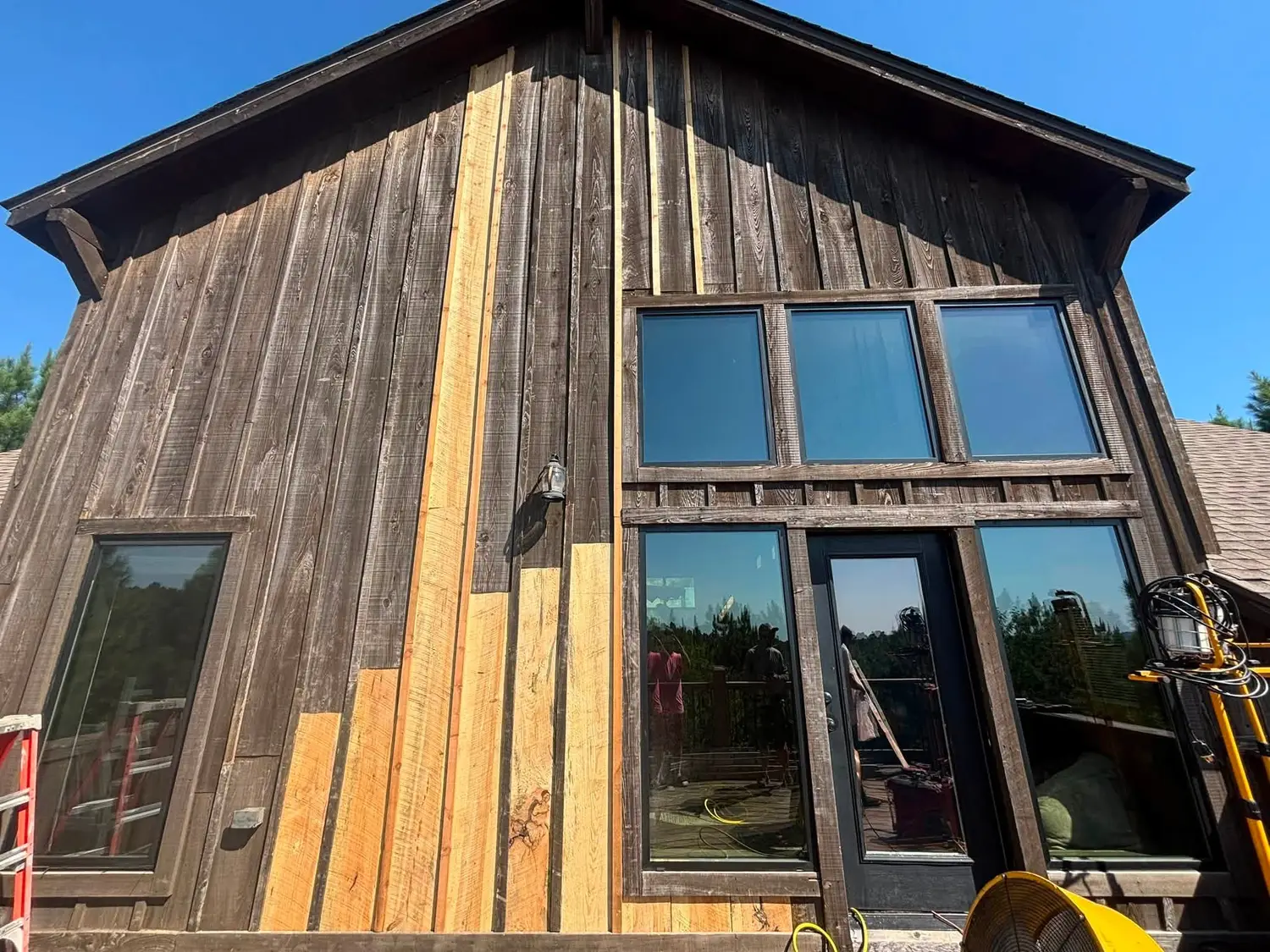 Cabin gable with new board and batten wood siding and trim repaired by Kiamichi Custom Homes and Remodeling in southeast Oklahoma