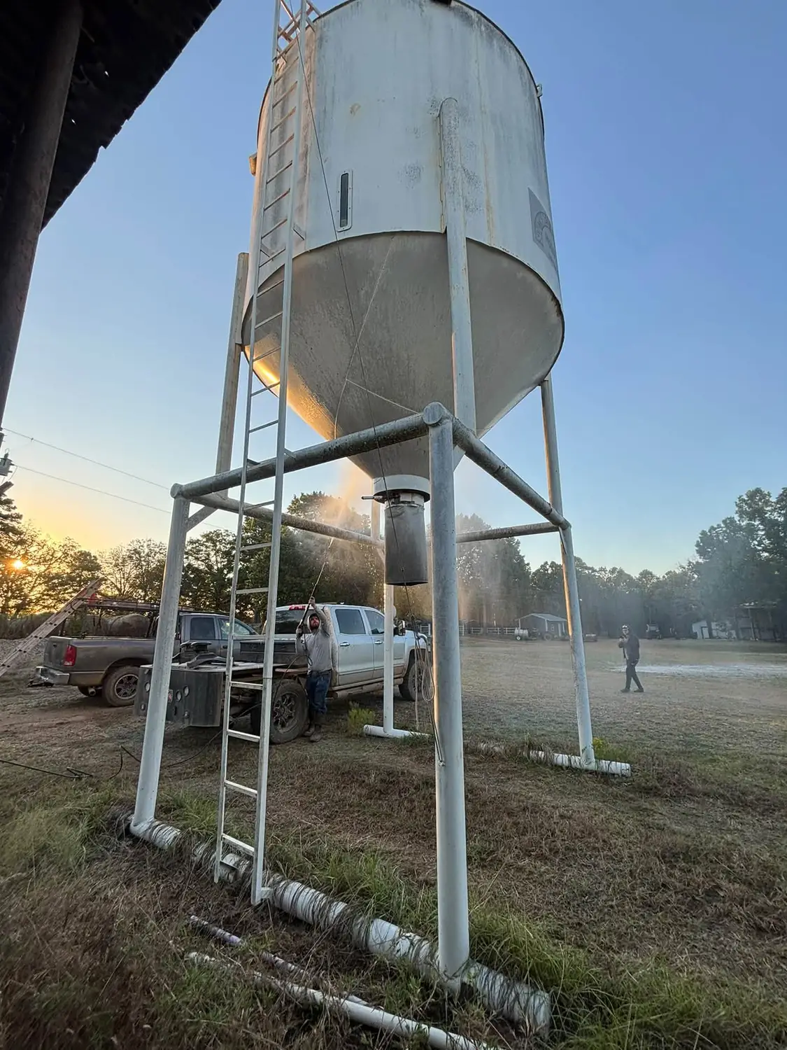 Feed silo freshly repainted white by Brush and Roller in Antlers, Oklahoma