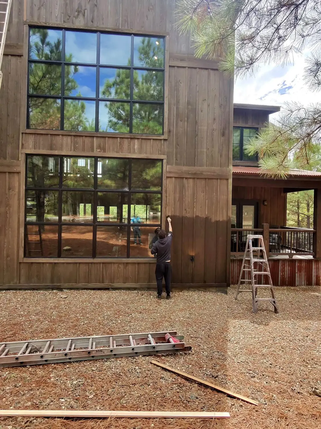 Brush and Roller crew working on cabin exterior wood stain near Broken Bow and Hochatown