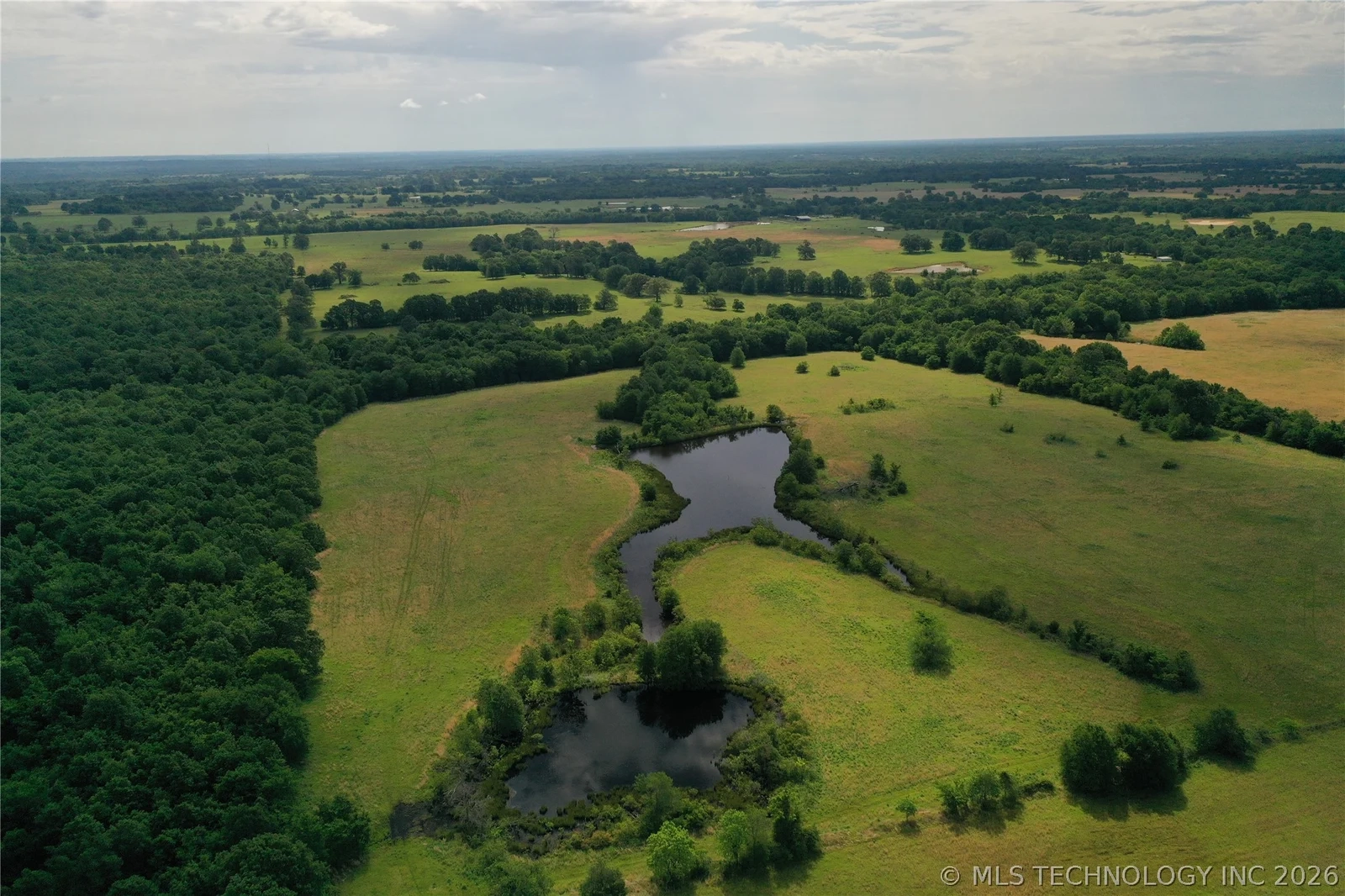 80 acres sold at 4055 Rd, Boswell, OK – aerial of ponds and pasture | Love My Texoma Home Team