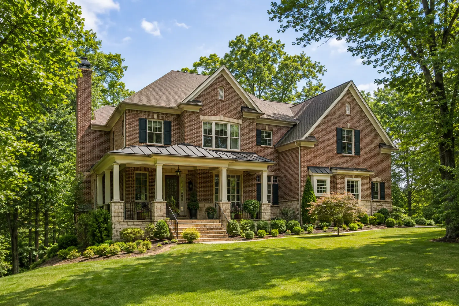 Tennessee brick home framed by wooded hills and mature landscaping