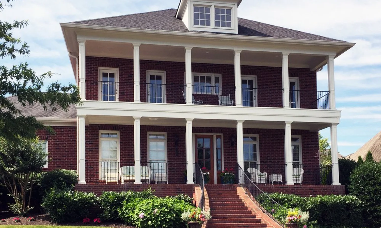 Brick Tennessee home with a broad front porch