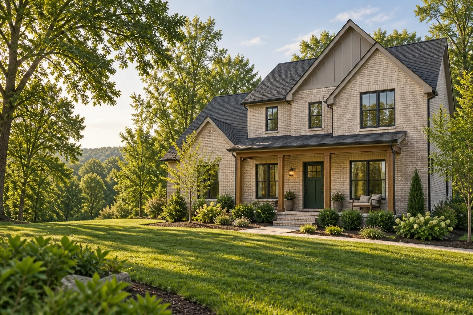 Illustrative new brick home with a green front door, covered porch and landscaped yard