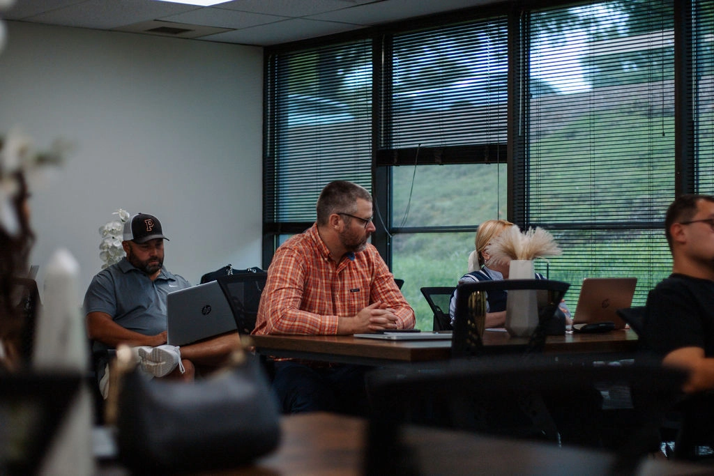 Colleagues listening during a MaX House team meeting