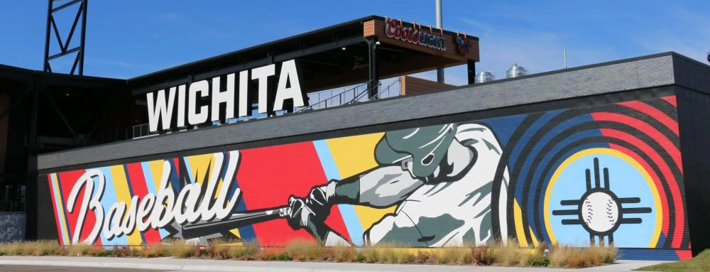 Riverfront Stadium Mural an image of a mural of someone swinging a bat on the exterior wall of riverfront stadium