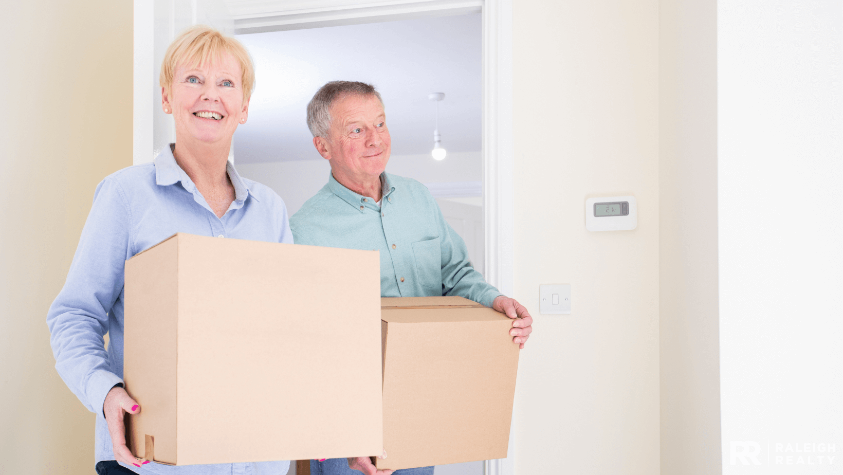 Older folks packing a room that used to be their childs room who has gone off to college