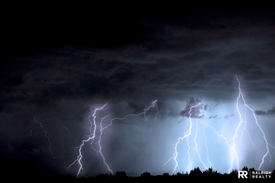 Lightning at night time lights up the sky and is the precursor to a storm