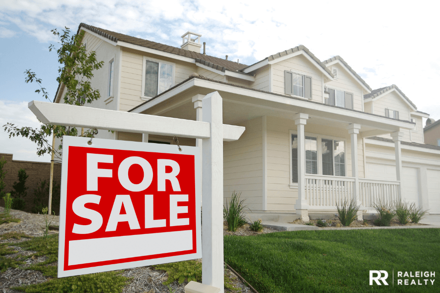 For Sale sign in the front yard of a home as the sellers prepare to list while buying a home