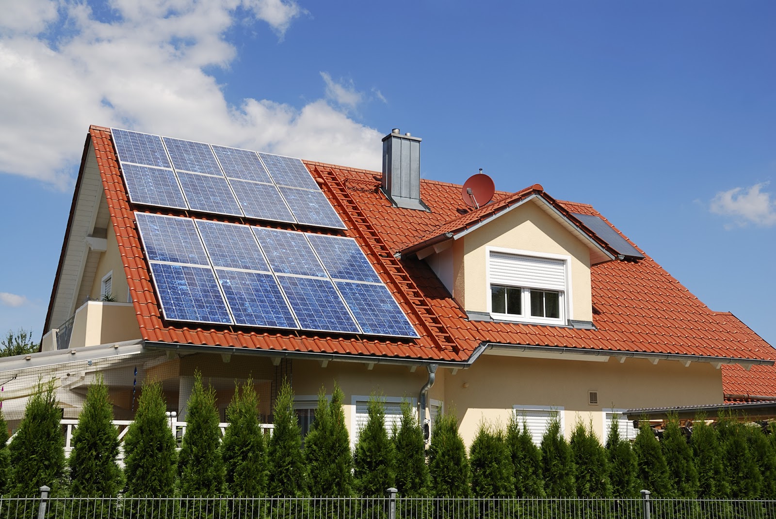 A beautiful home with solar panels installed on the roof.