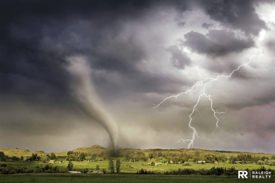 Tornado and lightning with homes and buildings in the midst of the storms path 