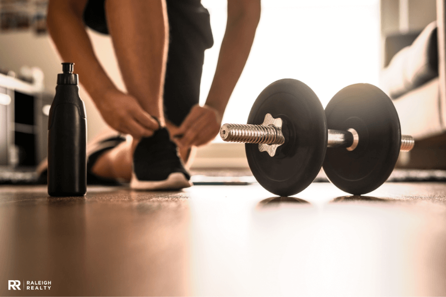 Lady tying her shoes at home as she prepares for a home workout