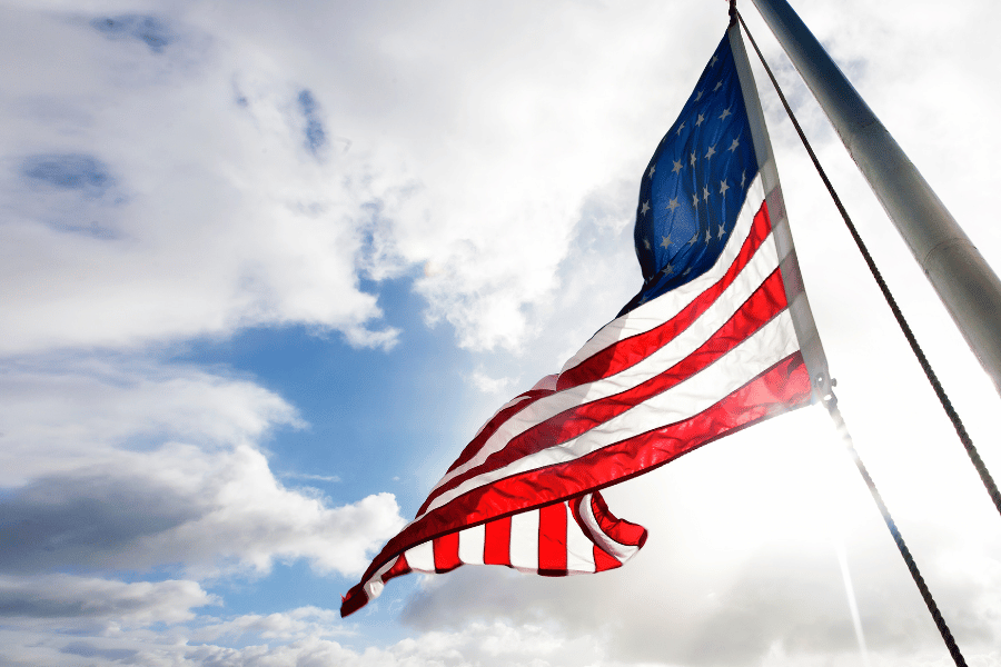 American flag blowing in the wind on a flag pole