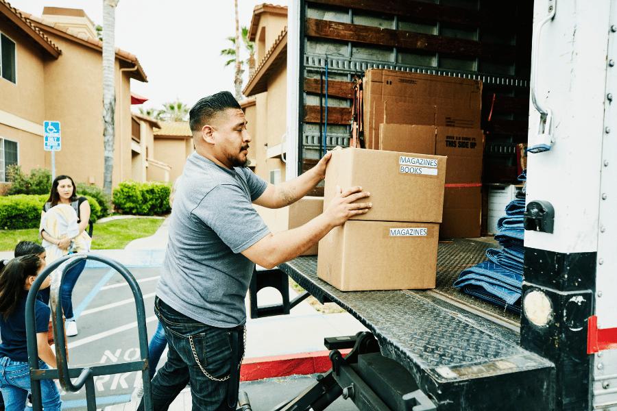 Young family moving to a new location and loading up the moving truck