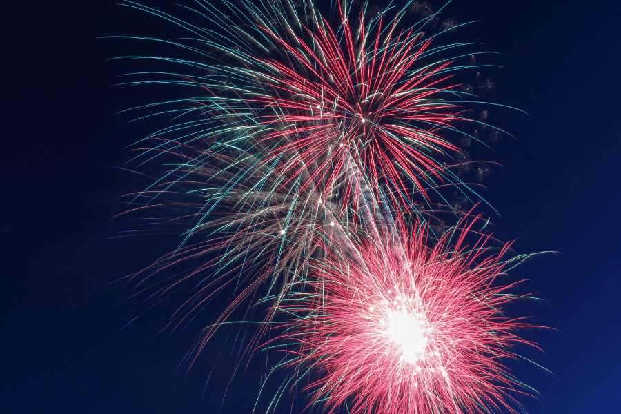 red and green colorful fireworks in the sky on fourth of july