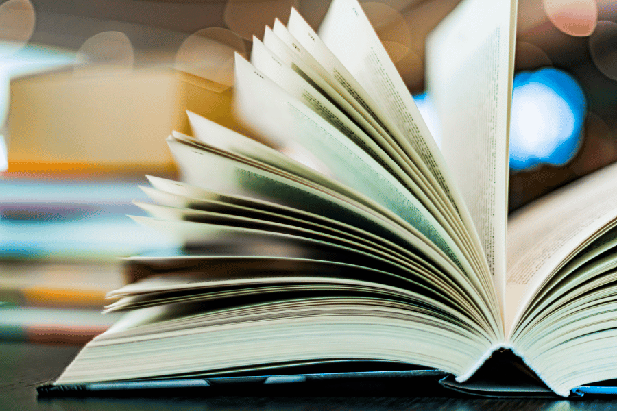 open hardcover book on a table at the library