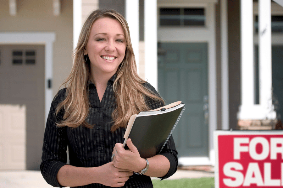 realtor in front of home for sale pricing home 